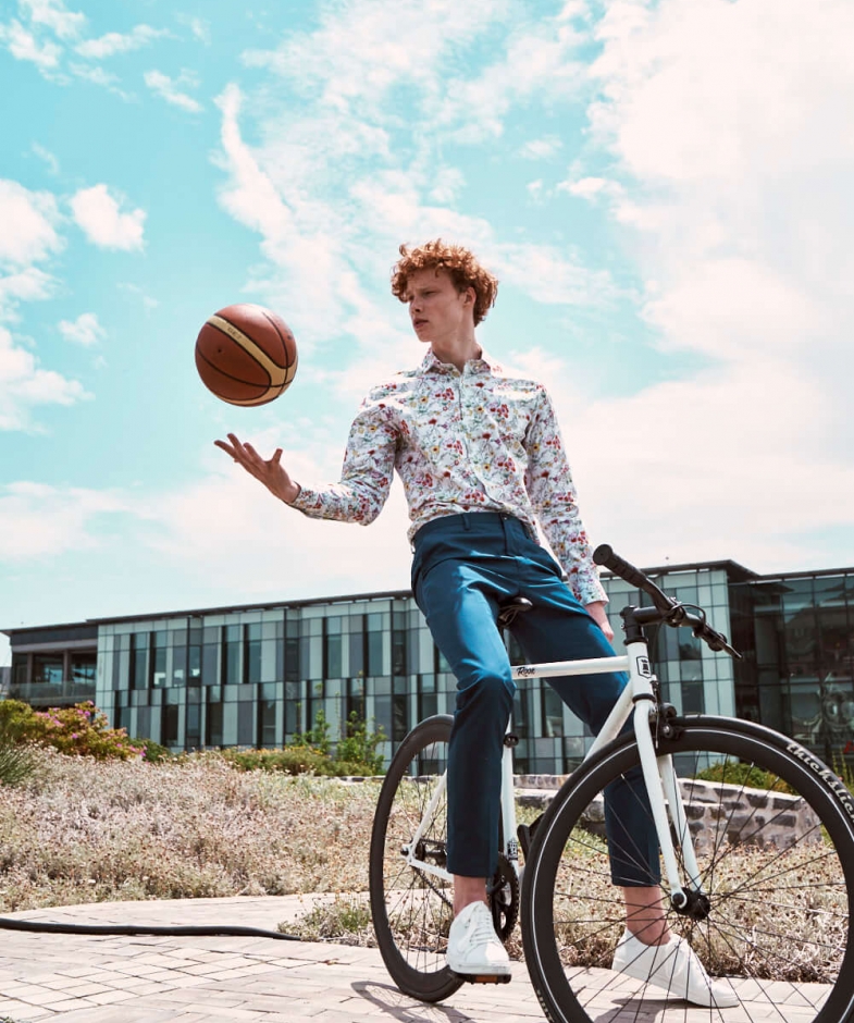 Boy on bicycle with a basketball 